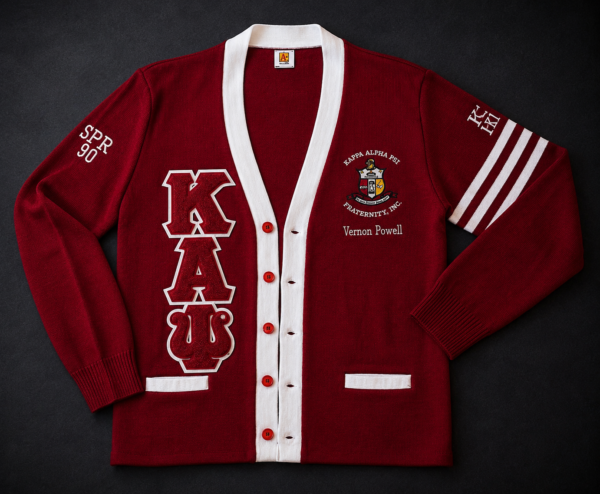 Custom crimson and white Greek letter cardigan sweater with large chenille letters, full-color heraldic crest, personalized name, sleeve embroidery, and athletic stripes.