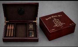 Rosewood piano-finish humidor shown open with cigars and accessories beside a closed engraved lid