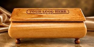Red alder wood keepsake box on ball feet with an engraved "YOUR LOGO HERE" plaque on the lid