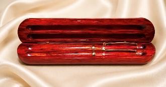 Open rosewood two-groove case holding a matching rosewood pen and pencil